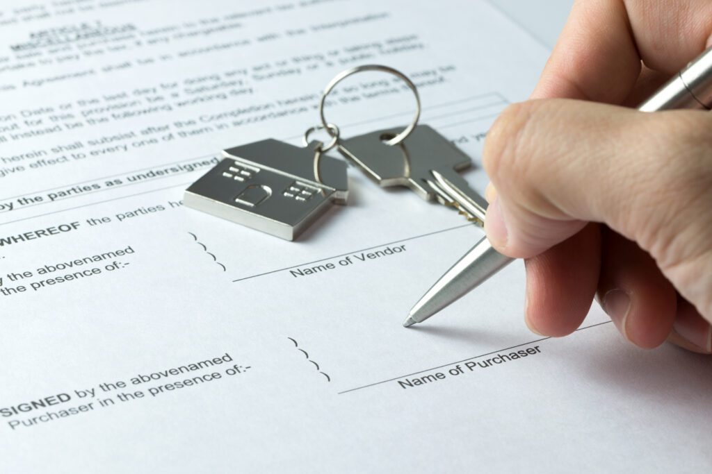 Person signing home title paperwork